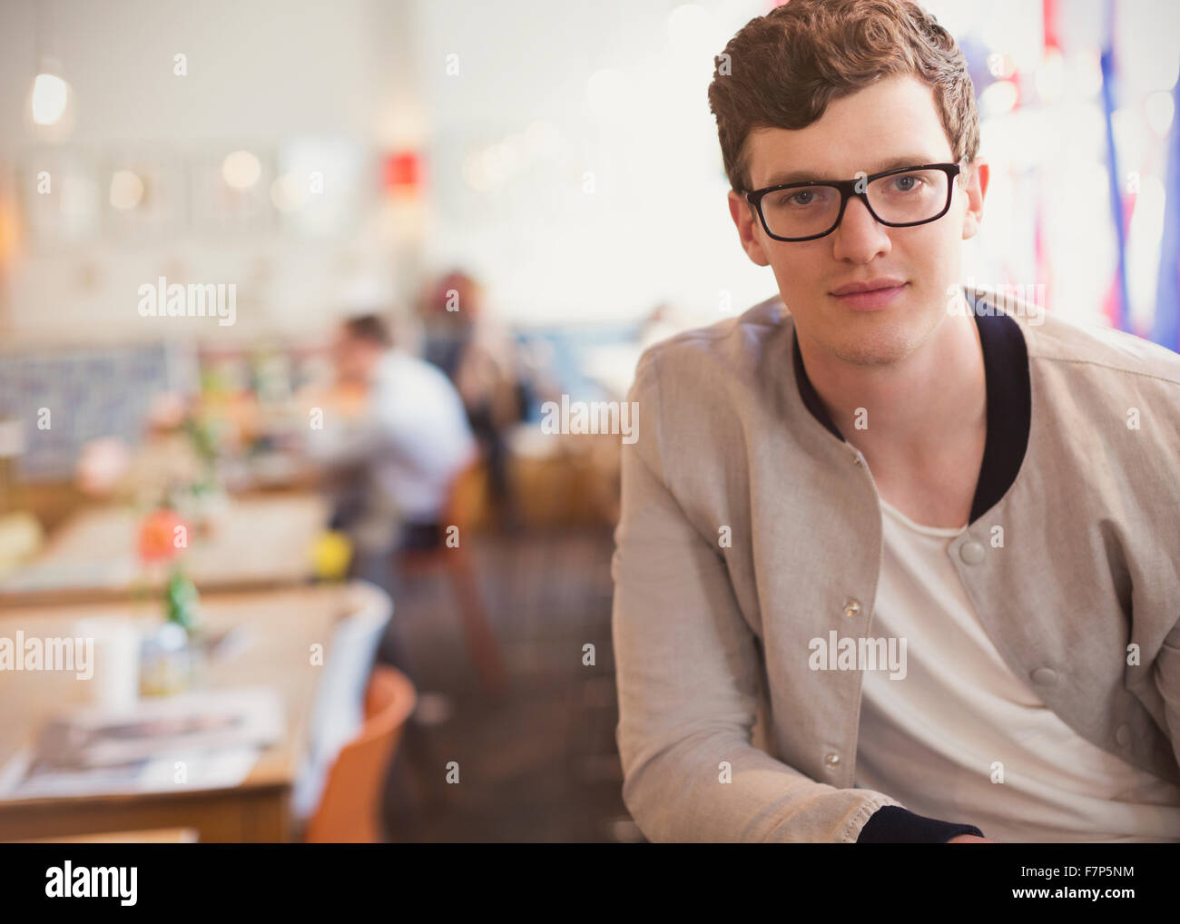 Portrait confident man with eyeglasses in cafe Stock Photo
