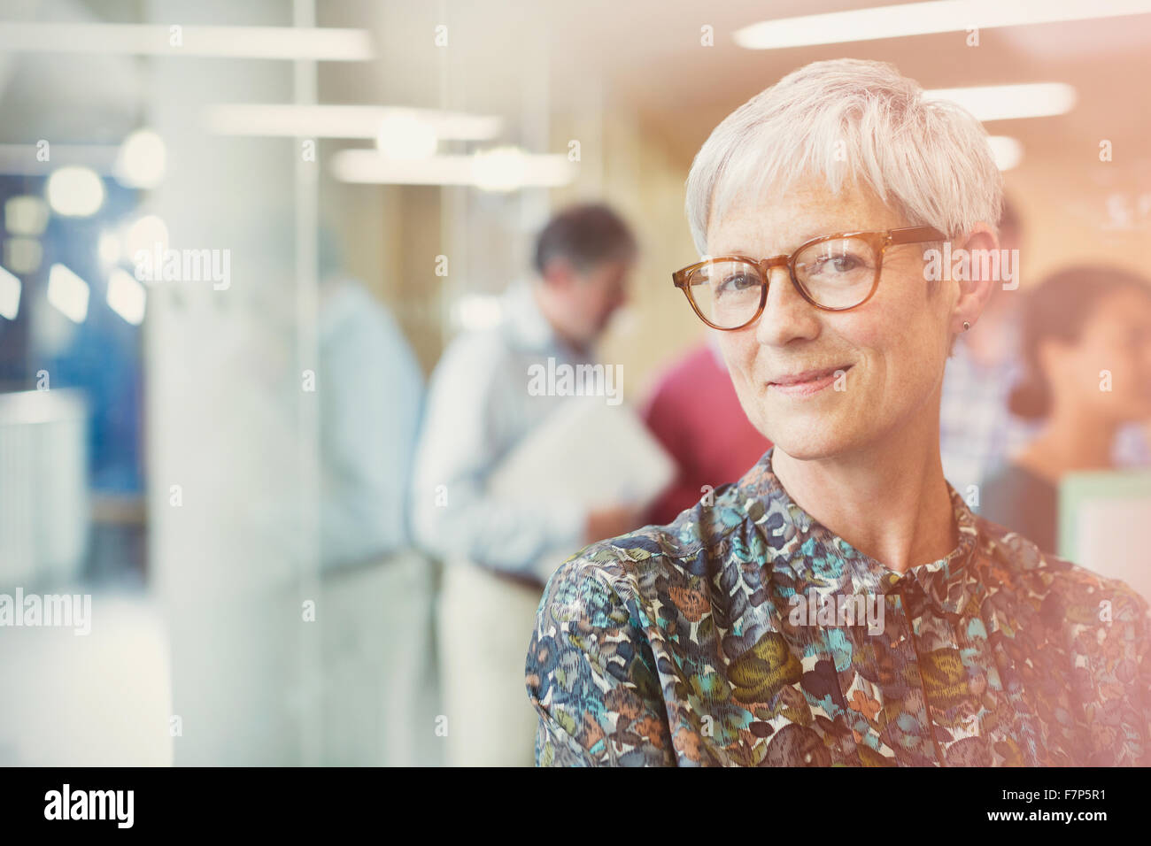 Portrait smiling senior businesswoman in office Stock Photo - Alamy