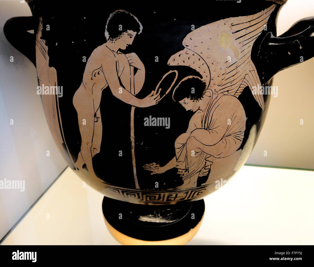 Red-figured bell-krater (wine-bowl) with two youths and Eros playing knucklebones made in Lucania and attributed to the Amykos Painter. Dated 420 BC Stock Photo