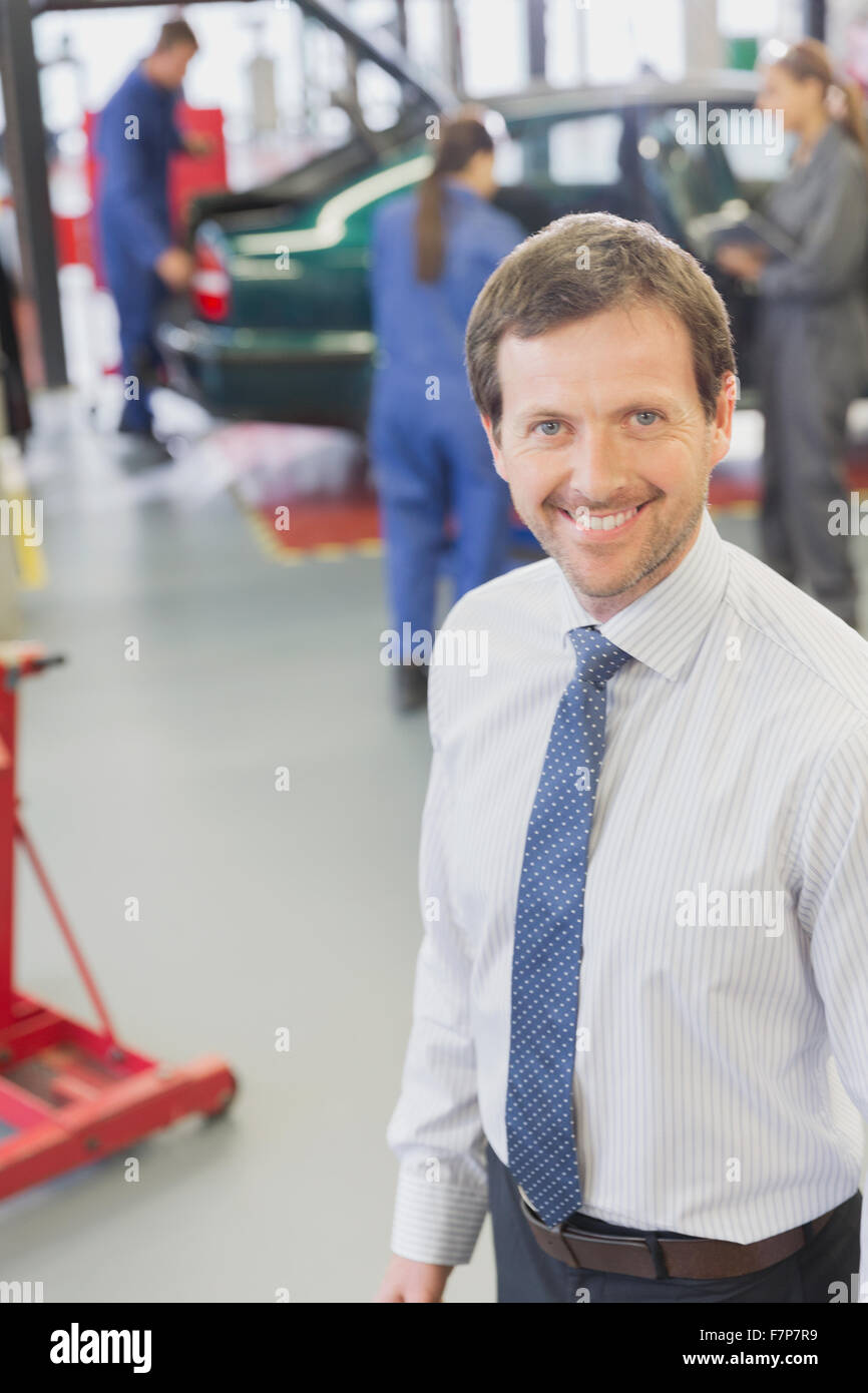 Portrait smiling businessman in auto repair shop Stock Photo Alamy