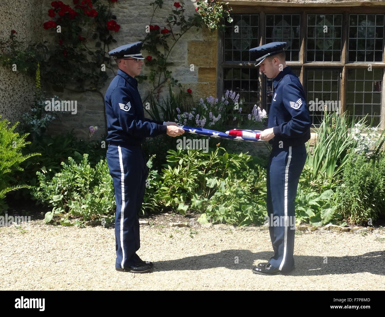 Flag lowering ceremony by US Air force servicemen at Sulgrave Manor, England, ancestral home of George Washington. 2015 Stock Photo