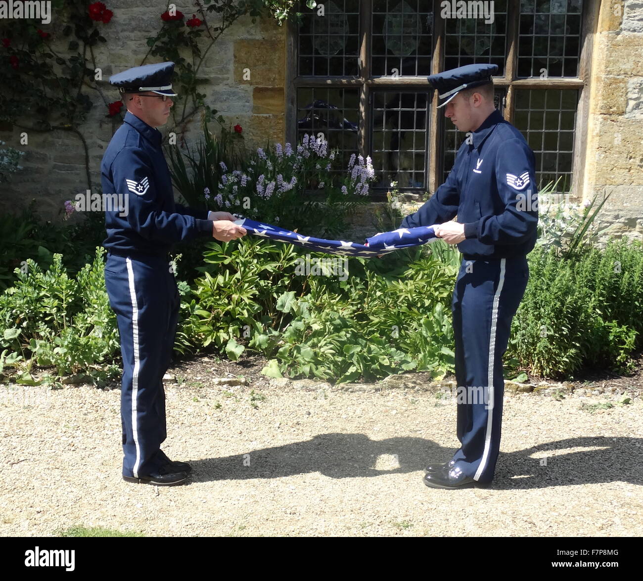 Flag lowering ceremony by US Air force servicemen at Sulgrave Manor, England, ancestral home of George Washington. 2015 Stock Photo