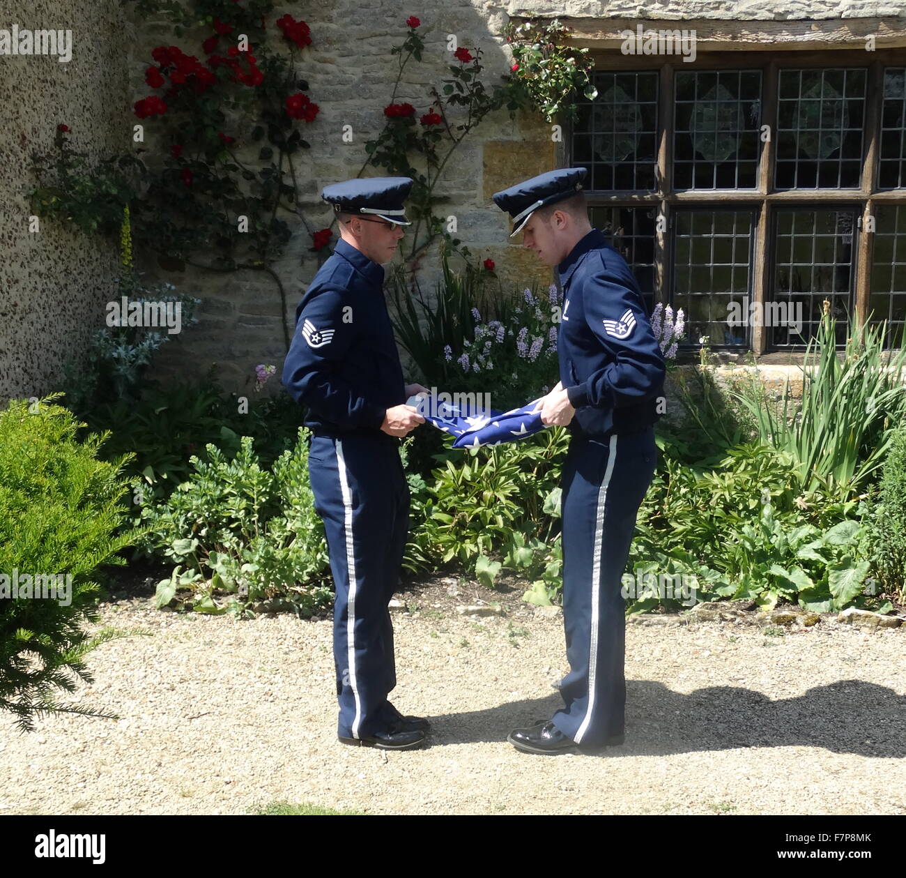 Flag lowering ceremony by US Air force servicemen at Sulgrave Manor, England, ancestral home of George Washington. 2015 Stock Photo