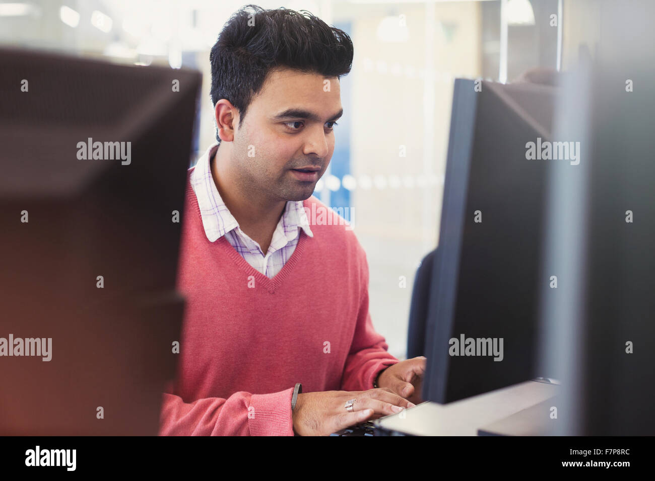 Man typing at computer in adult education classroom Stock Photo