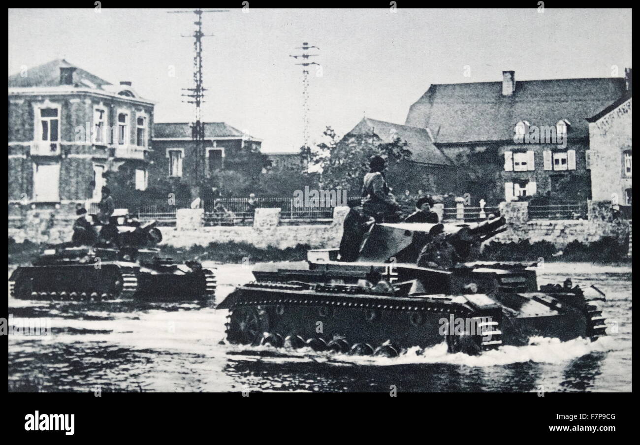 German armed forces are show travelling through difficult terrain in a Belgium town. Taken c1940, during the advance of the German forces through the european countries. Stock Photo