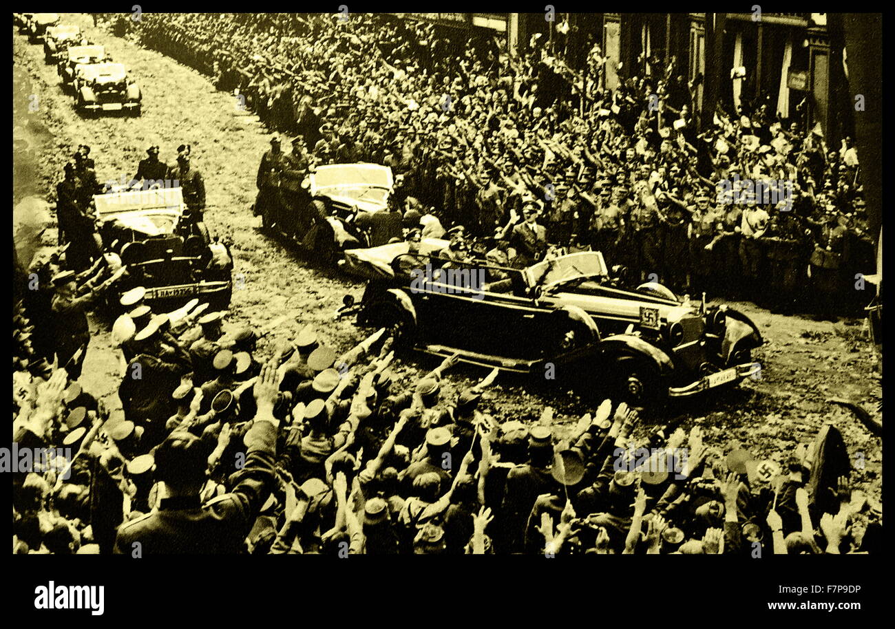 Adolf Hilter is shown saluting Nazi supporters from his car during a rally, taken shortly after the occupation of France in 1940, during the Second World War. Stock Photo