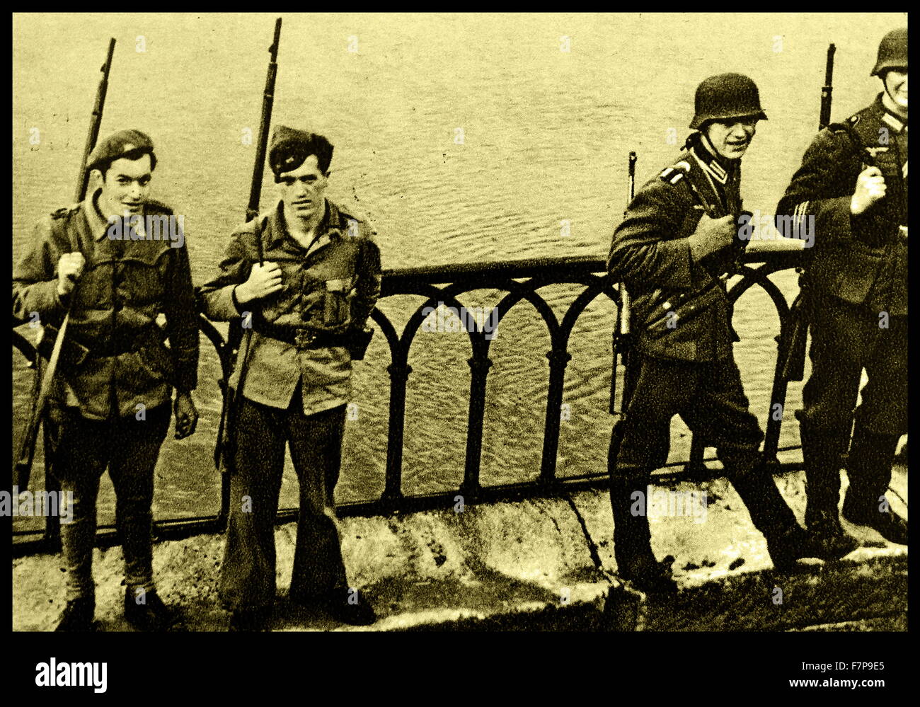 German and Spanish troops patrol the Bidasoa bridge. After the occupation of France, guard patrols were steup to stop anyone seeking refuge. Dated 1940. Stock Photo