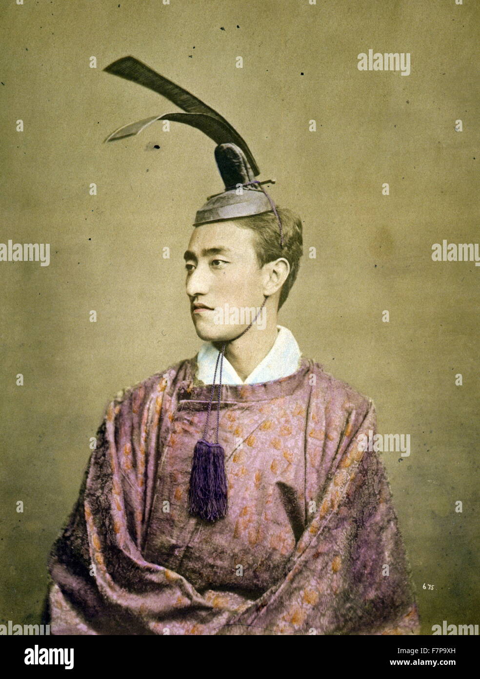 Photographic print, hand coloured with watercolour. Photograph shows a half-length studio portrait of a court official wearing a kanmuri (or kammuri), a crown-like hat worn by nobles and/or court officials. Stock Photo