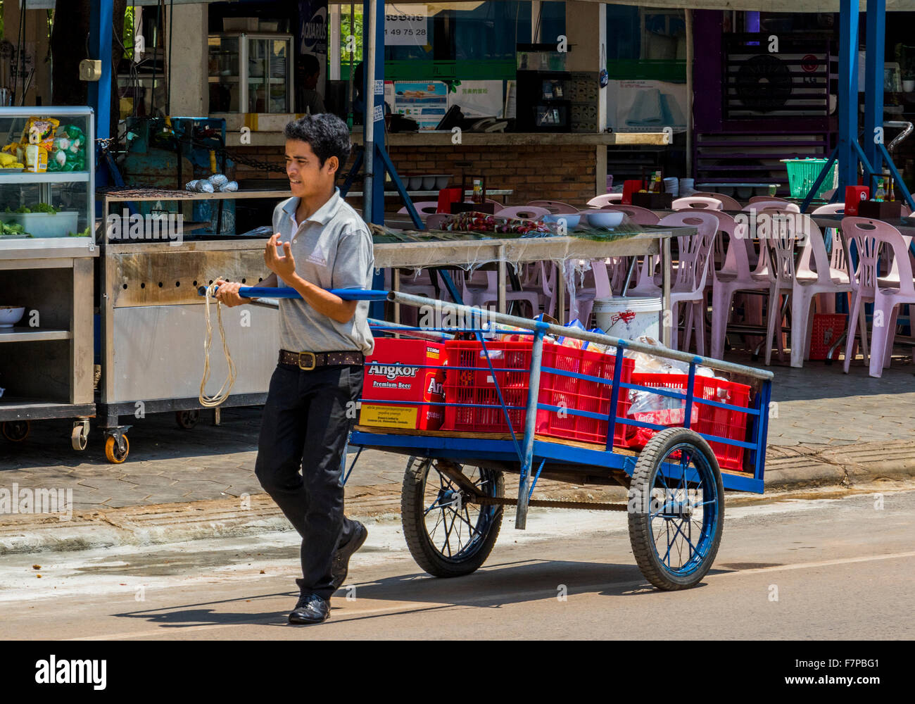 Trader dragging cart full of goods in Siem Reap Cambodia Stock Photo