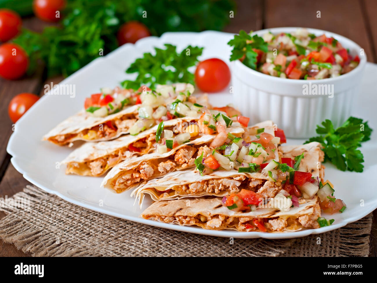 Mexican Quesadilla wrap with chicken, corn and sweet pepper and salsa. Stock Photo