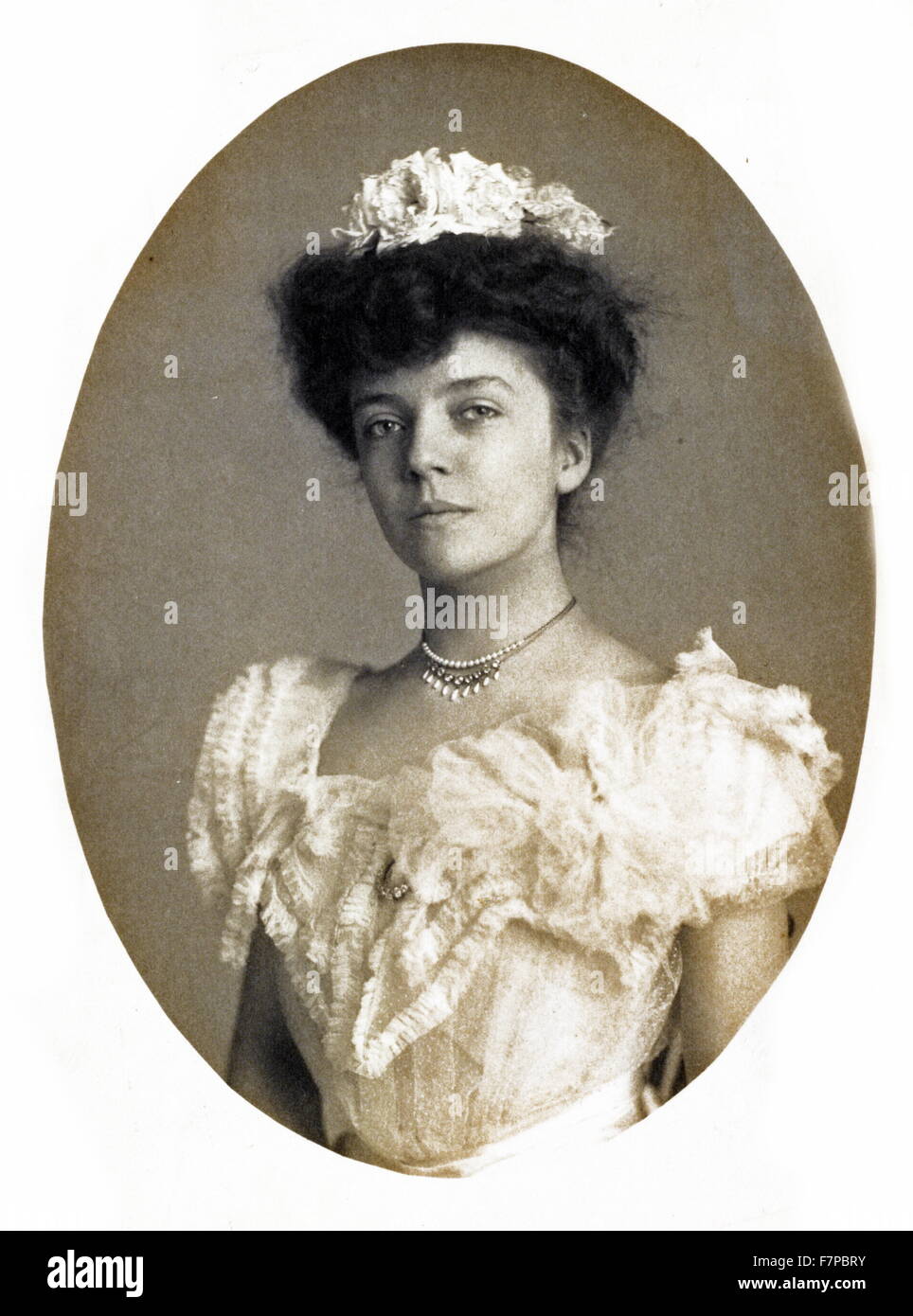 Woman wearing corset, brushing her hair, half-length portrait, standing,  facing front]