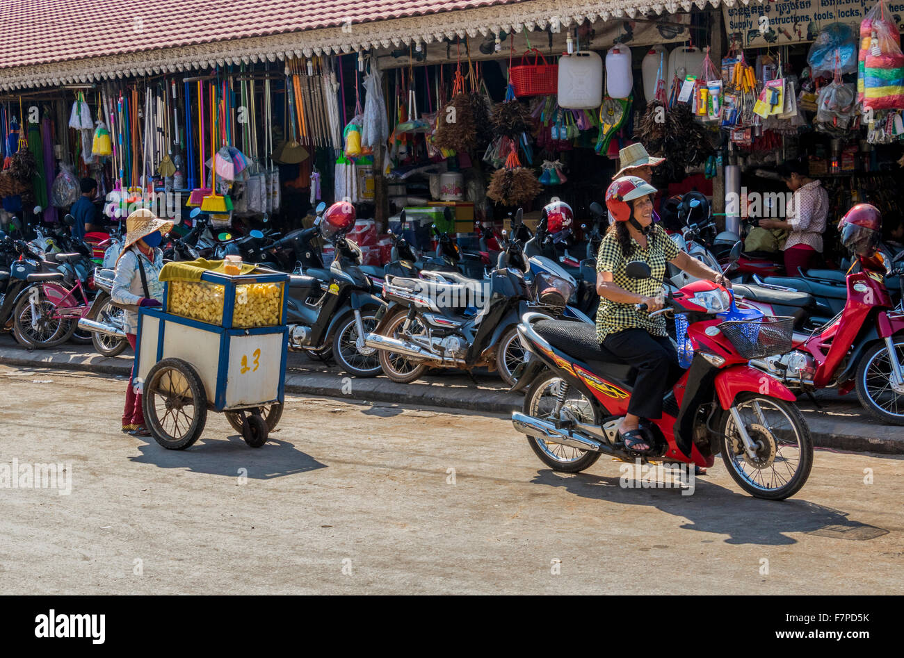 Mobile vendor at work on streets of Siem Reap where motor cycles are the main transport Stock Photo
