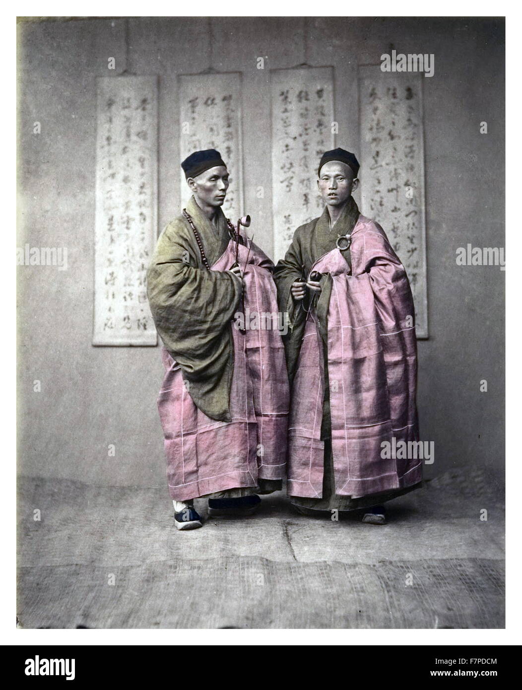 Chinese men in matching traditional dress, c, 1870s Stock Photo
