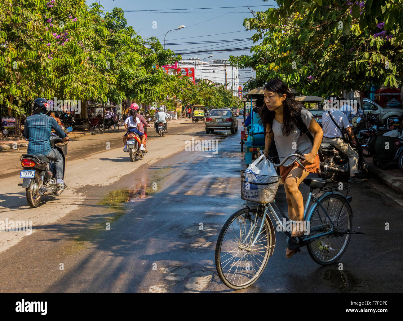 Girl on bicycle in Siem Reap Cambodia Stock Photo