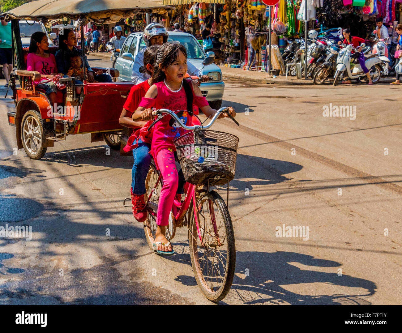 Two girls on bicycle in Siem Reap Cambodia Stock Photo