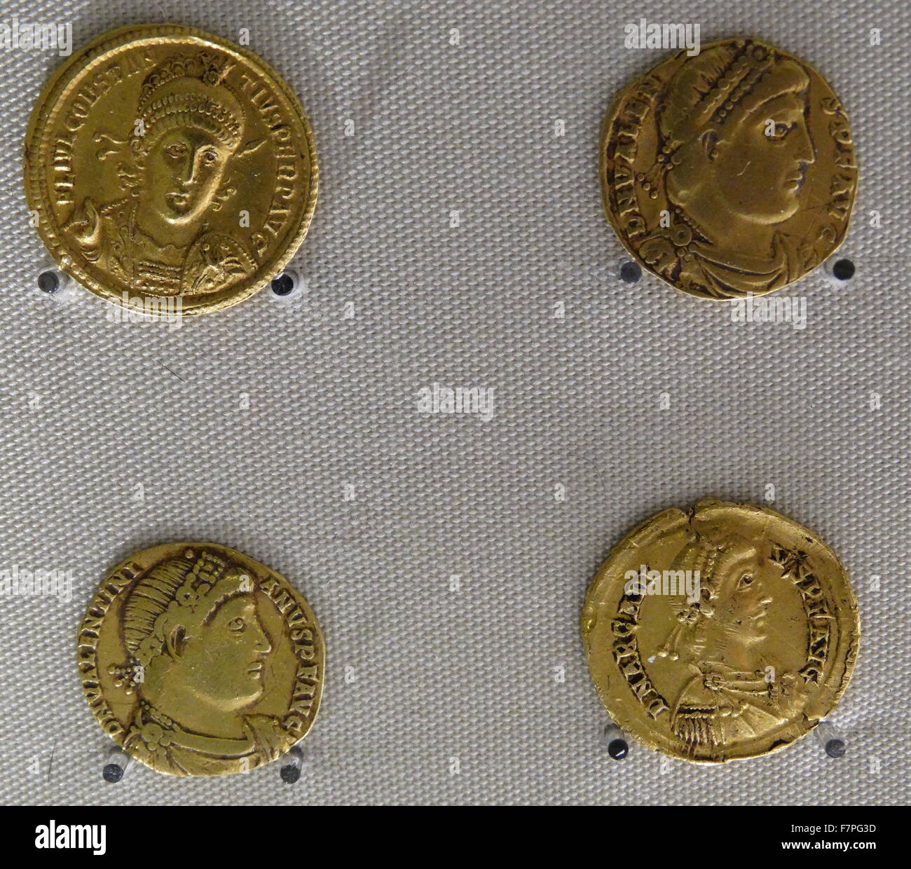 Four Roman Gold Coins issued by the Emperors Constantius II, Valetinian, Valens and Arcadius. Stock Photo