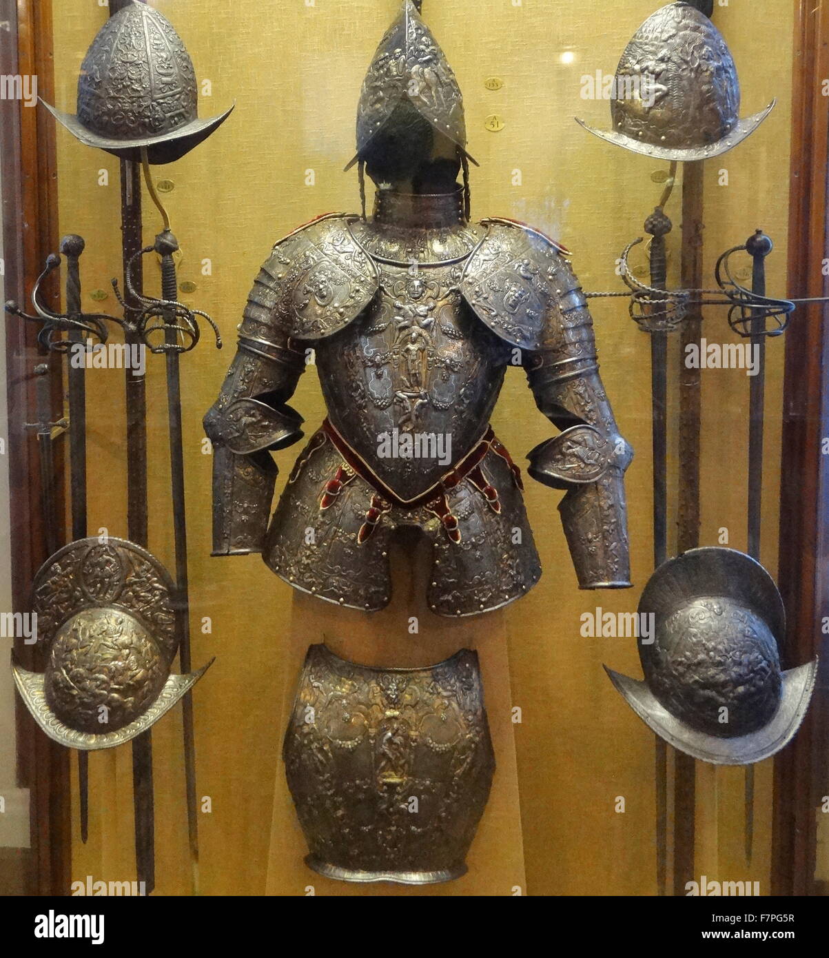 Half suit of armour from a group of parade armours. The surface of this armour is richly embossed with mythological figures including Mars, Hercules and the Nemean Lion. From Milan, made from iron, gold, silver and brass. Stock Photo