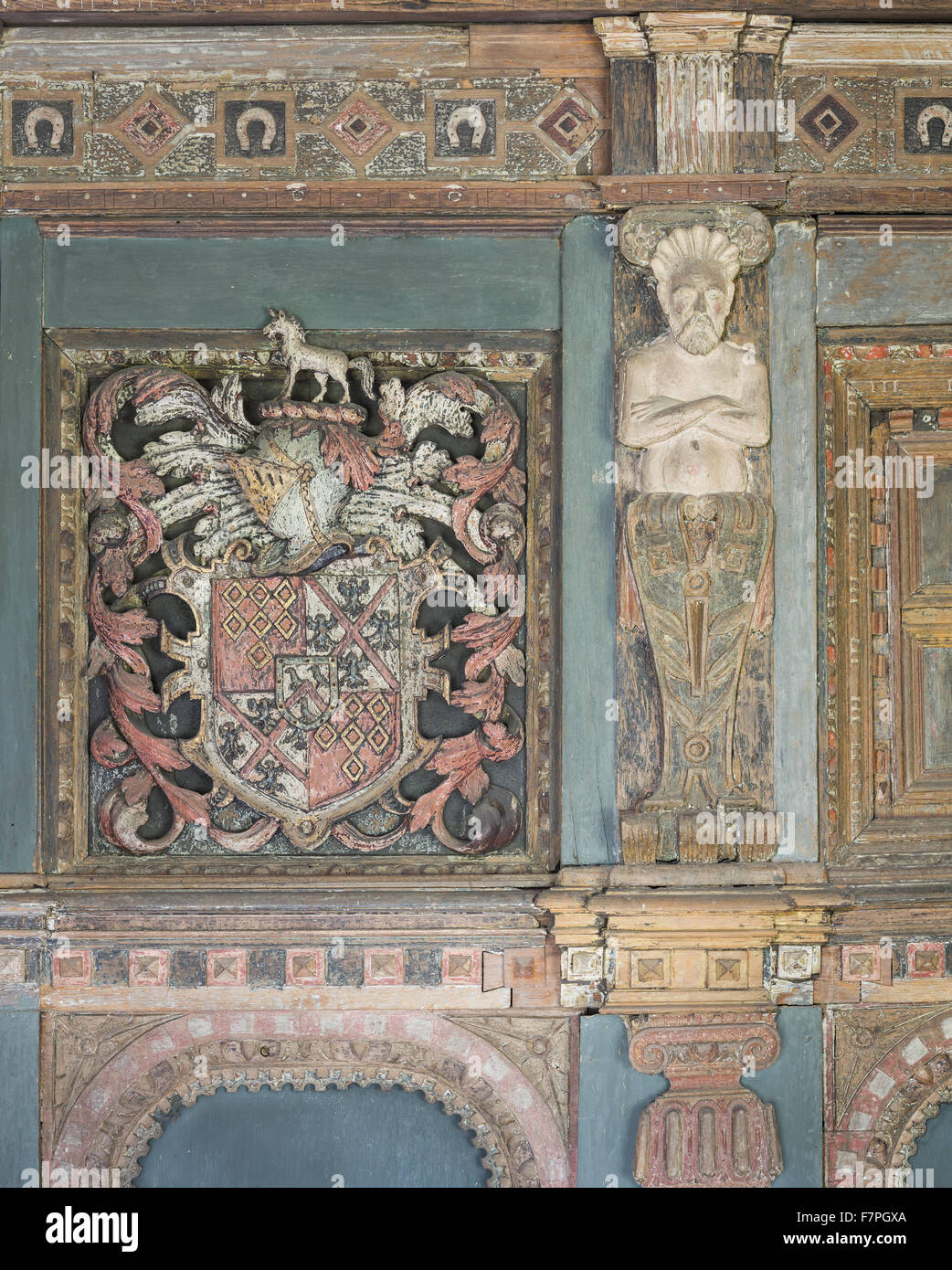 Detail of the elaborate wooden chimneypiece (c.1629) in Henry Ferrer's Bedroom, Baddesley Clinton, Warwickshire. The carving includes the arms of the Ferrers of Groby quartering Hampden (Henry's grandmother's family) and a shield of pretence in the centre Stock Photo