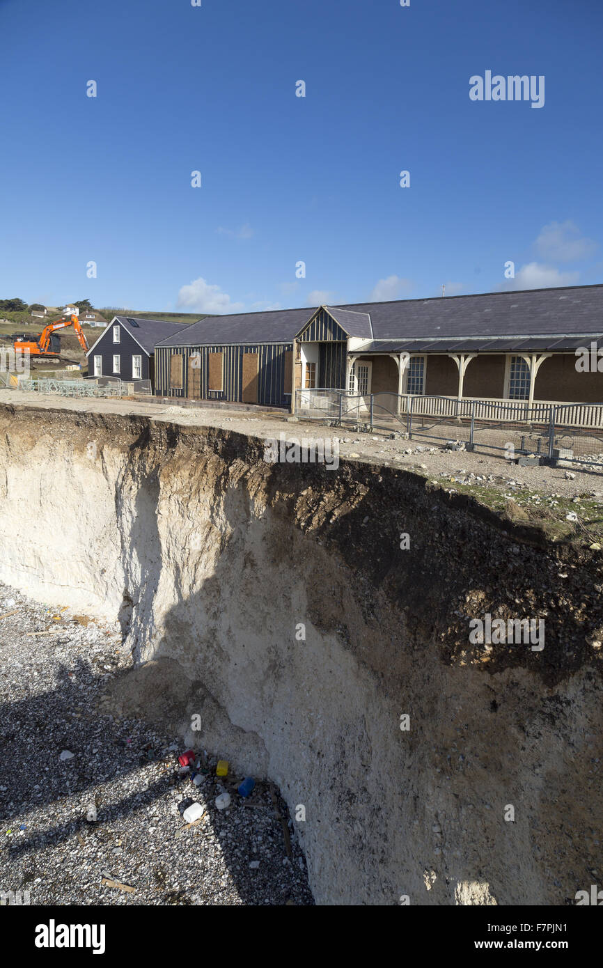 View of the storm-damaged cliffs at Birling Gap, East Sussex, pictured here in February 2014, with demolition work seen taking place on vulnerable clifftop buildings. Extreme weather in January and February of that year resulted in seven years' worth of e Stock Photo