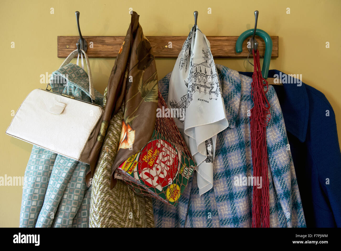 Coats on a coat rack at Anglesey Abbey, Gardens and Lode Mill, Cambridgeshire. Stock Photo