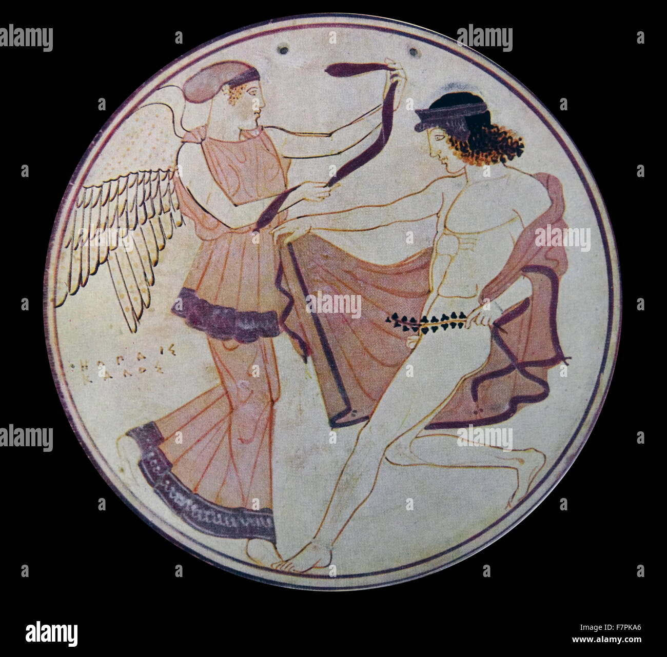 Greek painted disk depicting a Goddess offering a ribbon to a youth. Dated 450 BC Stock Photo
