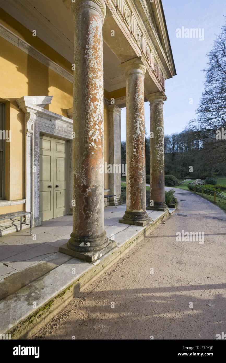 The facade of the Temple of Flora bathed in evening light at Stourhead