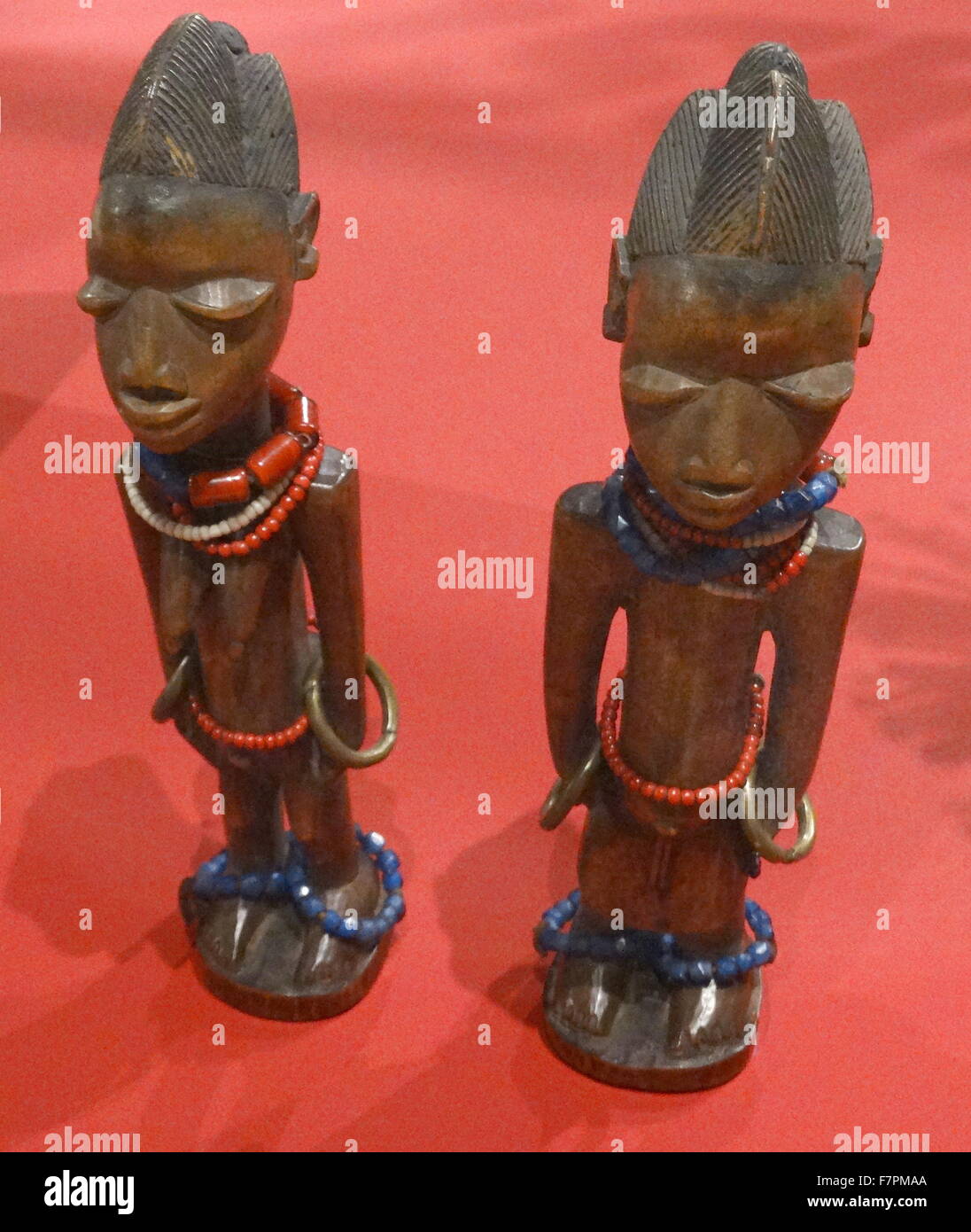 Wooden figures of deceased twins from the Yoruba people of Nigeria. Made from wood, beads and brass, 1870-1910. Stock Photo