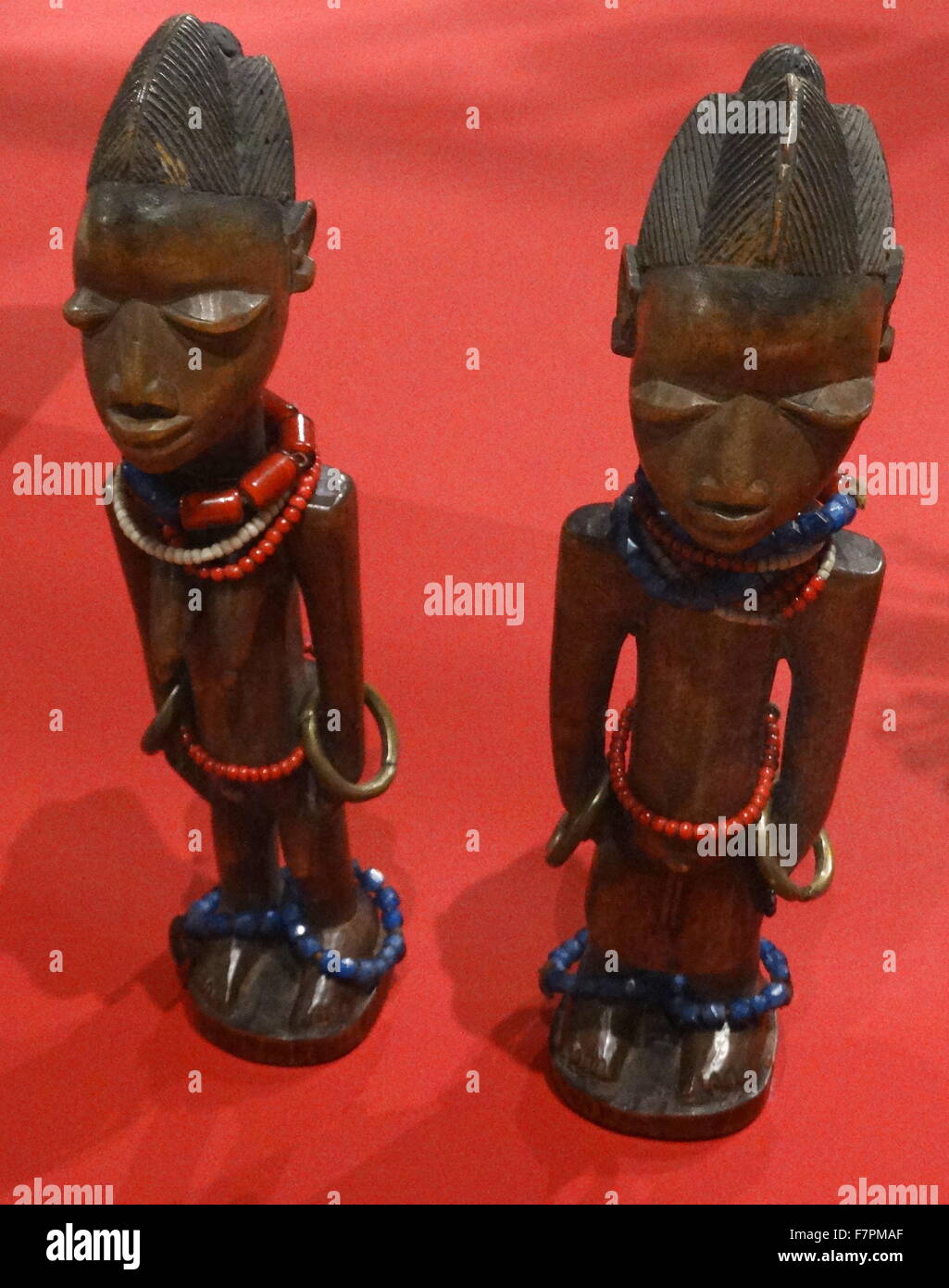 Wooden figures of deceased twins from the Yoruba people of Nigeria. Made from wood, beads and brass, 1870-1910. Stock Photo