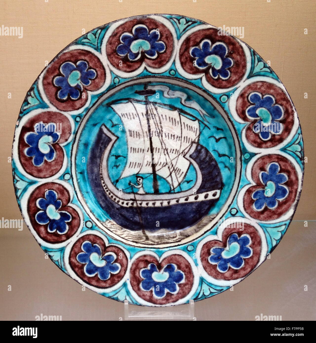 Earthernware plate painted with 'Persian' colours on a slip. Dated 1882 Stock Photo