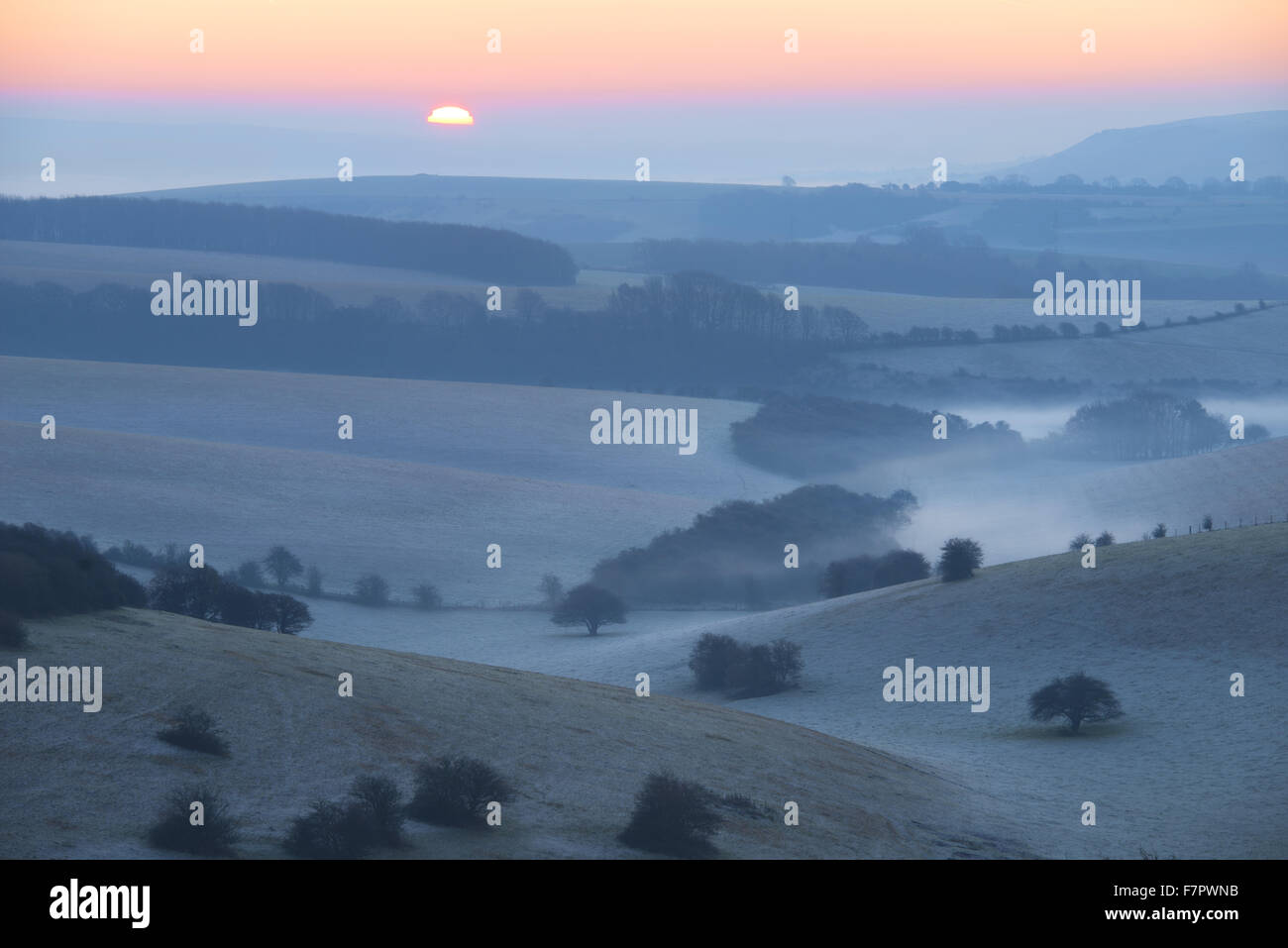 A misty view across the Sussex Downs at dawn, from Ditchling Beacon, East Sussex. Stock Photo
