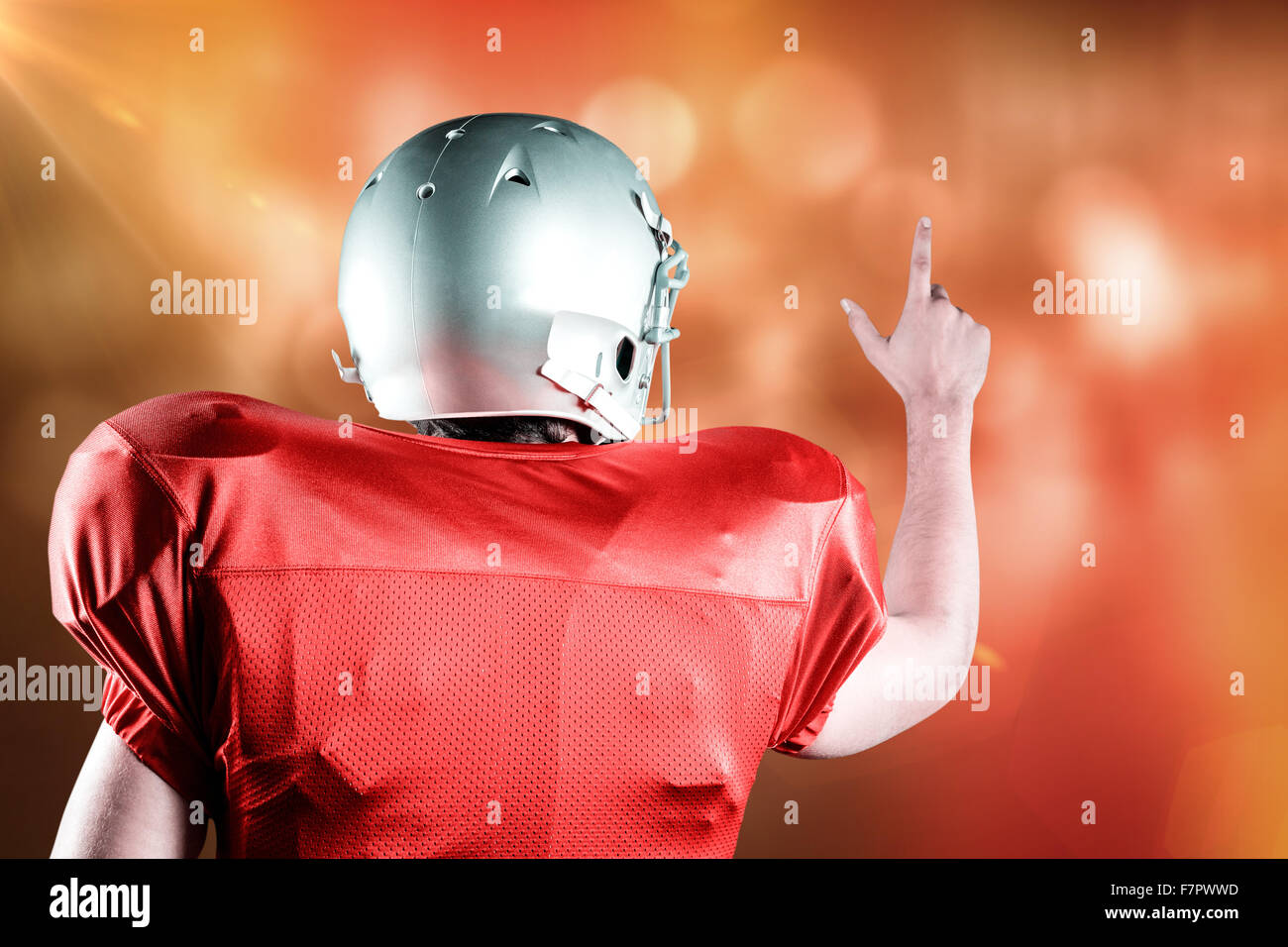 Composite image of rear view of american football player pointing Stock Photo