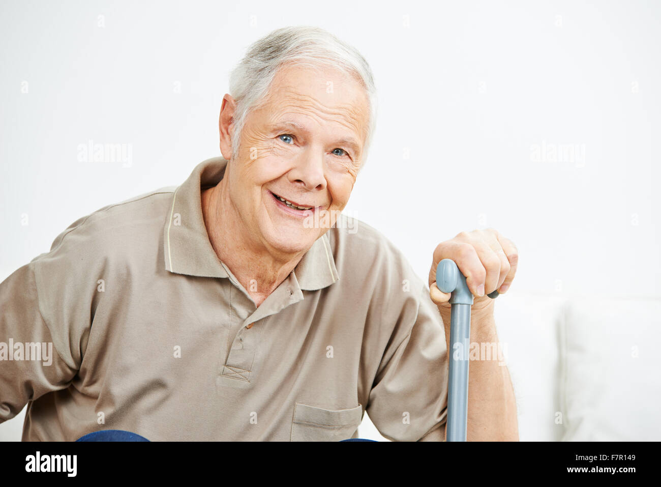 Old smiling senior man with his hand on a cane Stock Photo - Alamy