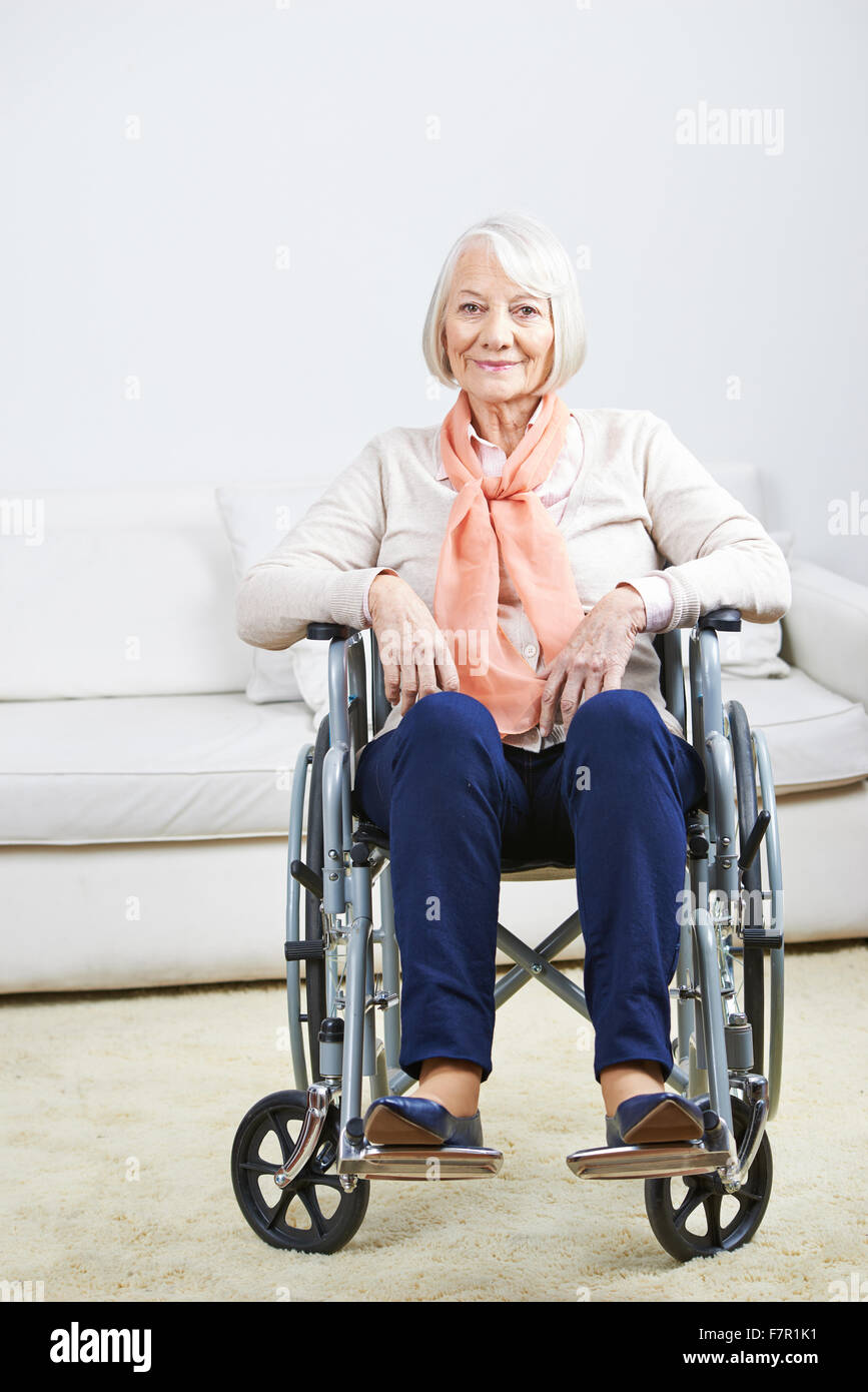 Smiling old senior woman in wheelchair at home Stock Photo