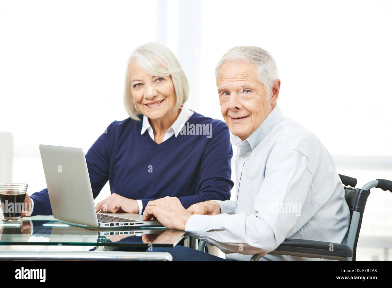 Senior couple with laptop computer using ecommerce online shopping in the internet Stock Photo