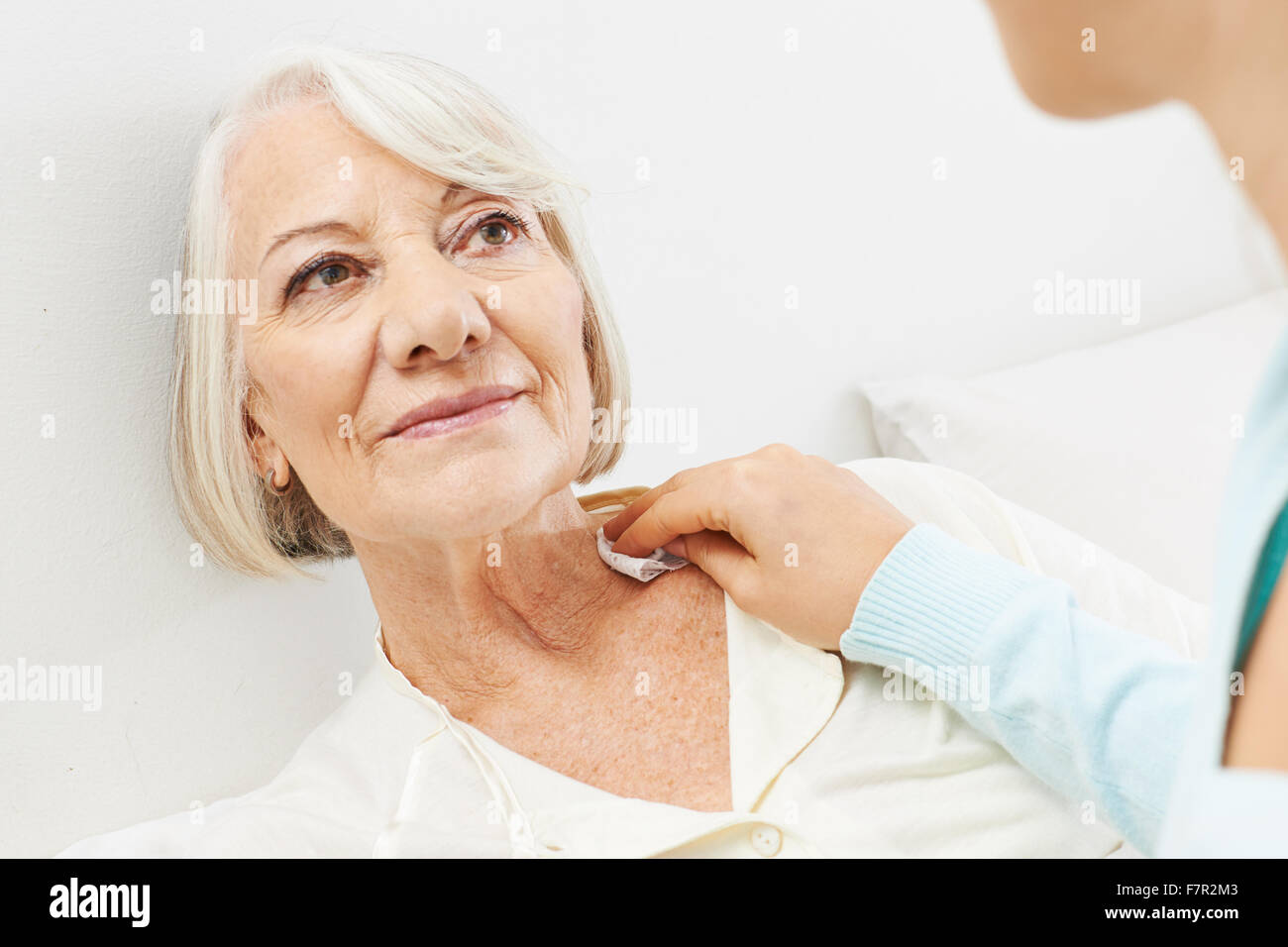 Woman helping bedridden senior woman washing at home Stock Photo Alamy
