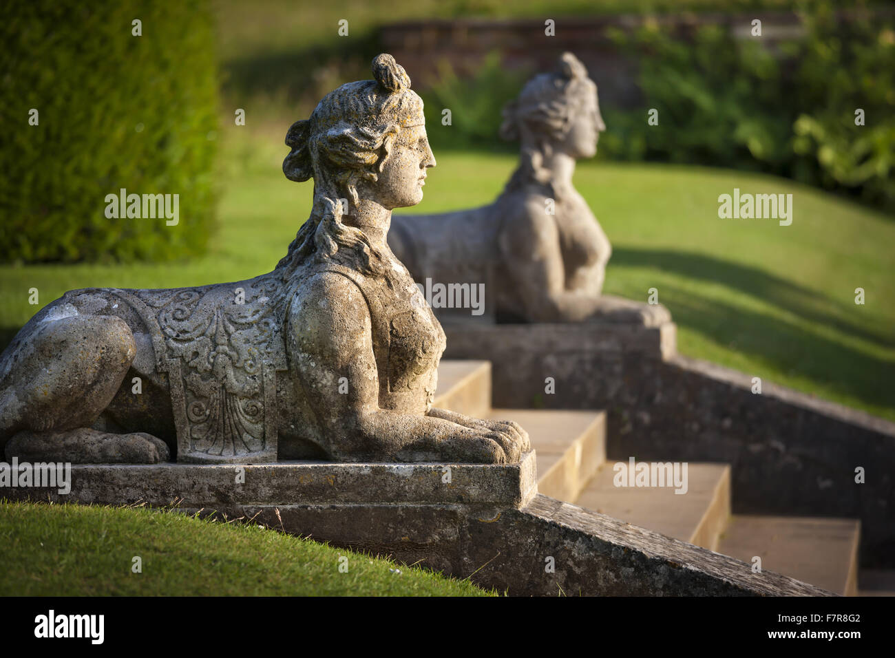 Sphinxes marking the steps from the parterre to the Temple walk at Blickling Estate, Norfolk. Blickling is a turreted red-brick Jacobean mansion, sitting within beautiful gardens and parkland. Stock Photo