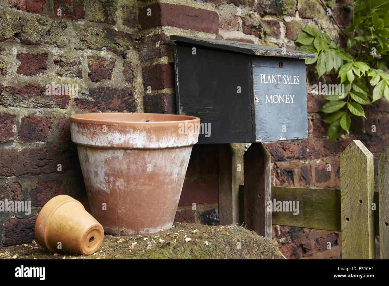 An honesty box in the garden at Fenton House and Garden, London. Fenton House was built in 1686 and is filled with world-class decorative and fine art collections. The gardens include an orchard, kitchen garden, rose garden and formal terraces and lawns. Stock Photo