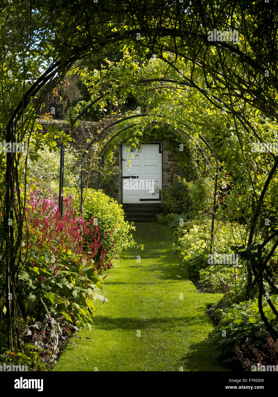 View along the garden borders and archways at Eyam Hall and Craft Centre, Derbyshire. Stock Photo