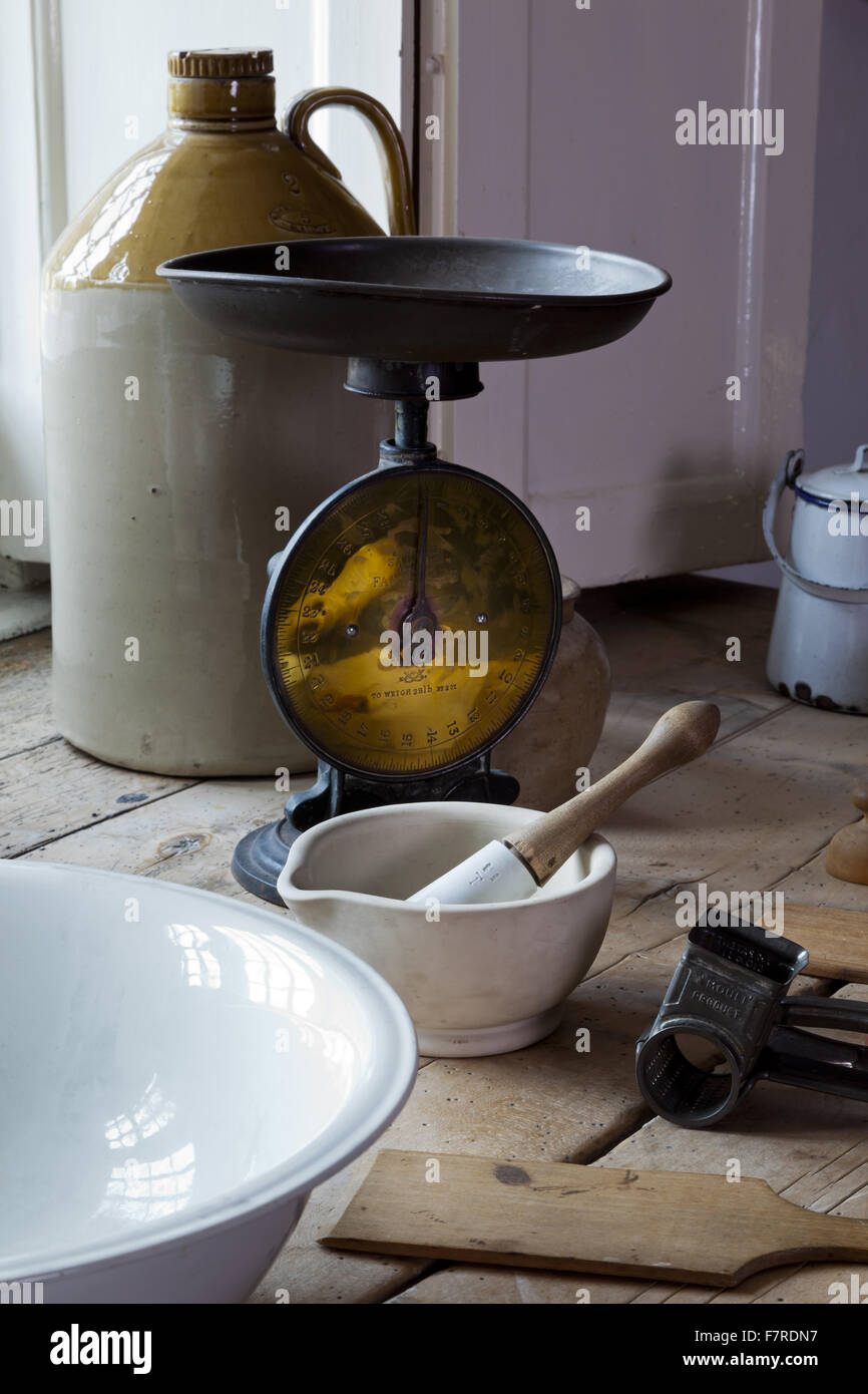Scales and cooking equipment in the Kitchen at Eyam Hall and Craft Centre, Derbyshire. Eyam Hall is an unspoilt example of a gritstone Jacobean manor house, set within a walled garden. Stock Photo