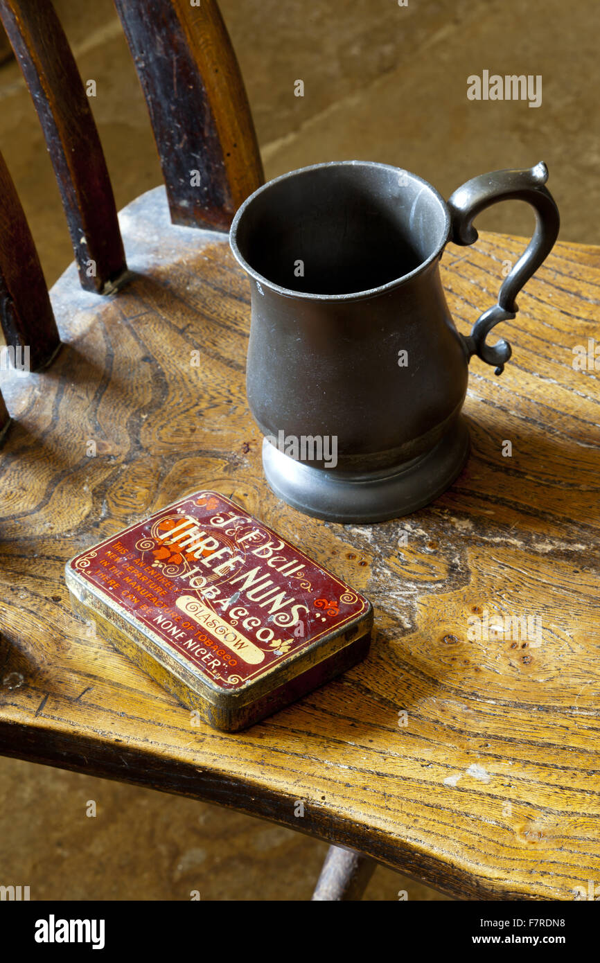 Tobacco tin and pewter tankard in the Kitchen at Eyam Hall and Craft Centre, Derbyshire. Eyam Hall is an unspoilt example of a gritstone Jacobean manor house, set within a walled garden. Stock Photo