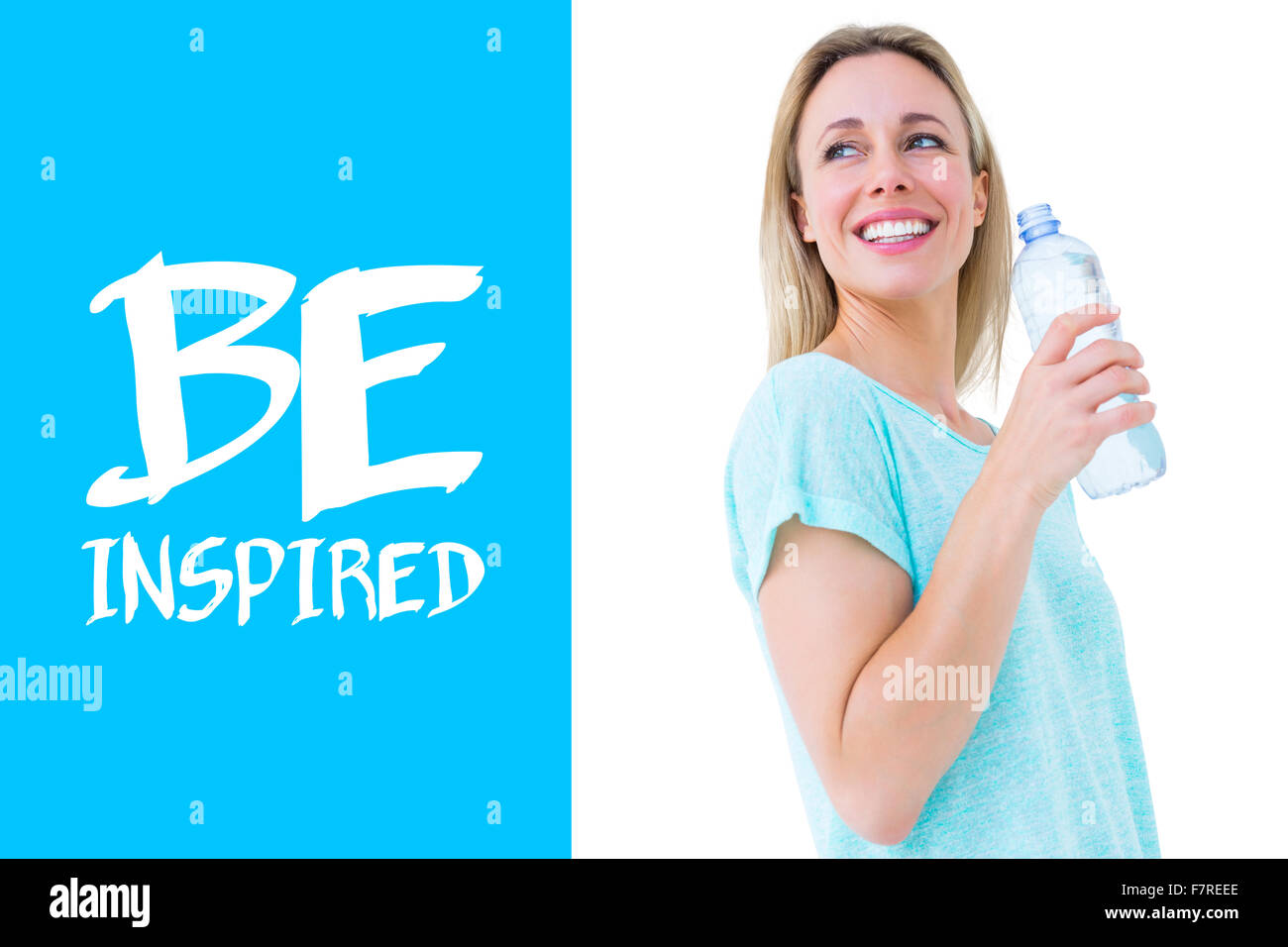 Composite image of smiling blonde holding bottle of water Stock Photo