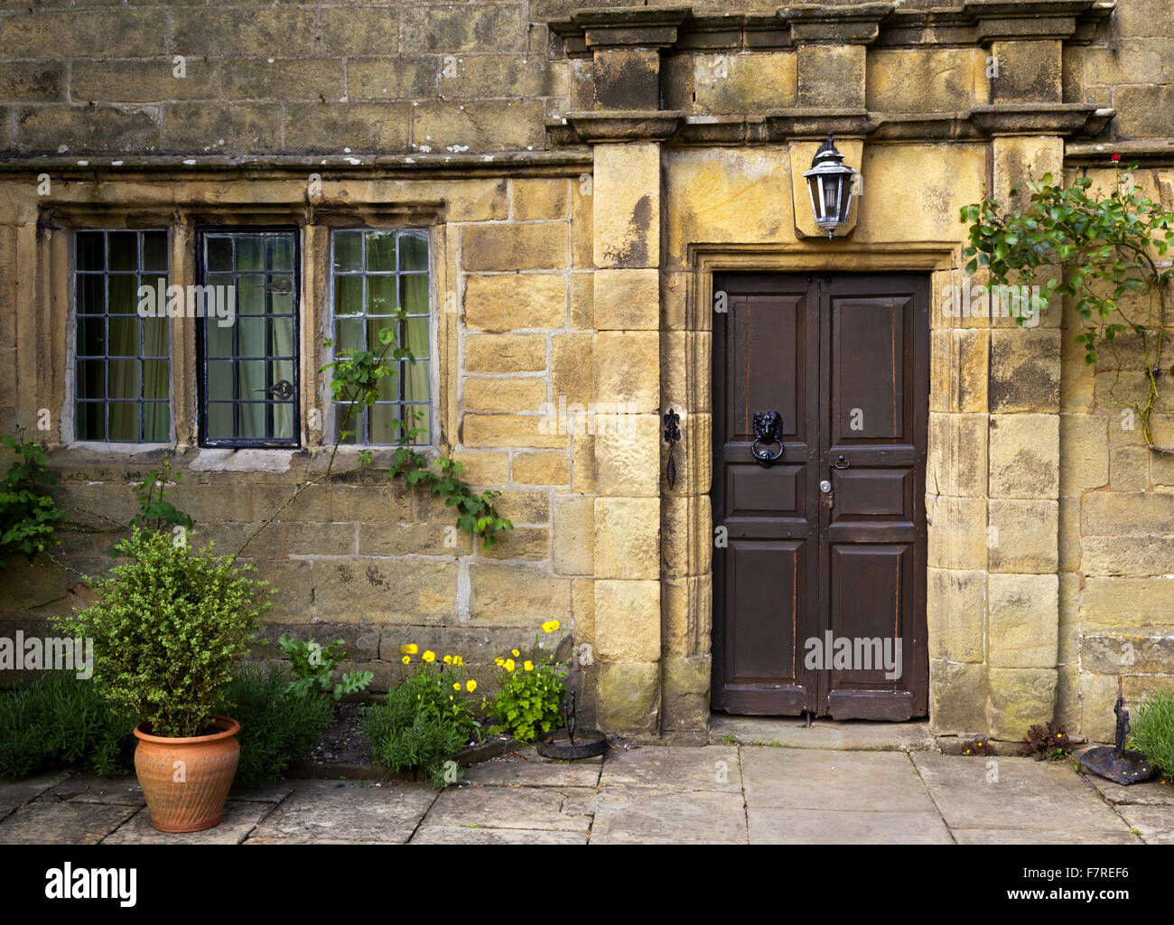 The front of Eyam Hall and Craft Centre, Derbyshire. Eyam Hall is an unspoilt example of a gritstone Jacobean manor house, set within a walled garden. Stock Photo
