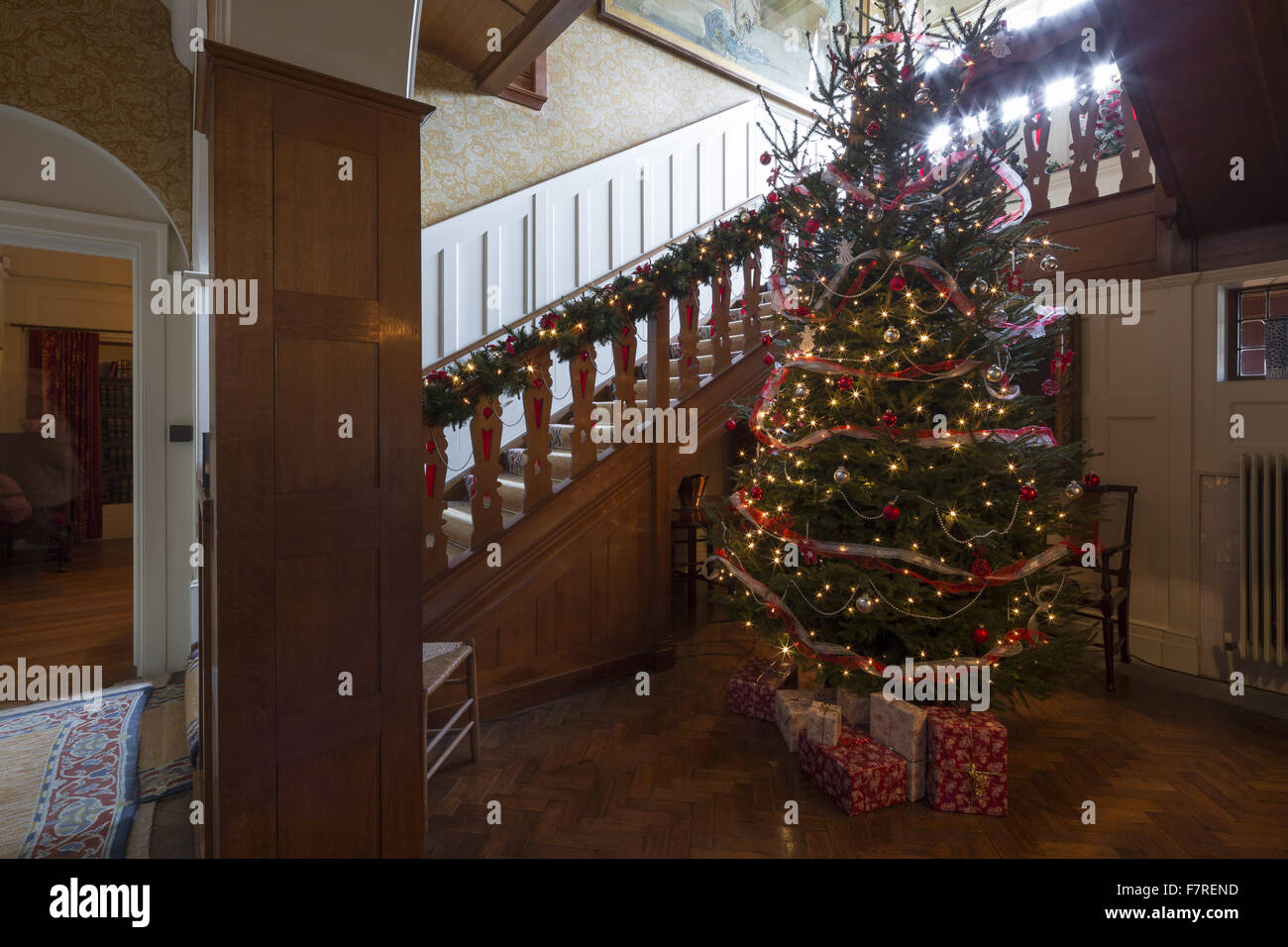 A decorated Christmas tree, in the Staircase Hall at Standen House and