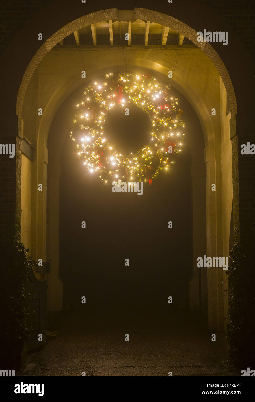 Giant Christmas wreath, glowing with fairy lights and hanging from an