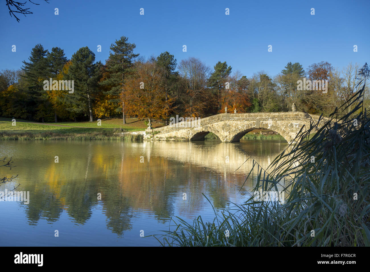 The Oxford Bridge in the autumn at Stowe, Buckinghamshire. Stowe is a landscaped garden with picture-perfect views, winding paths, lakeside walks and classical temples. Stock Photo