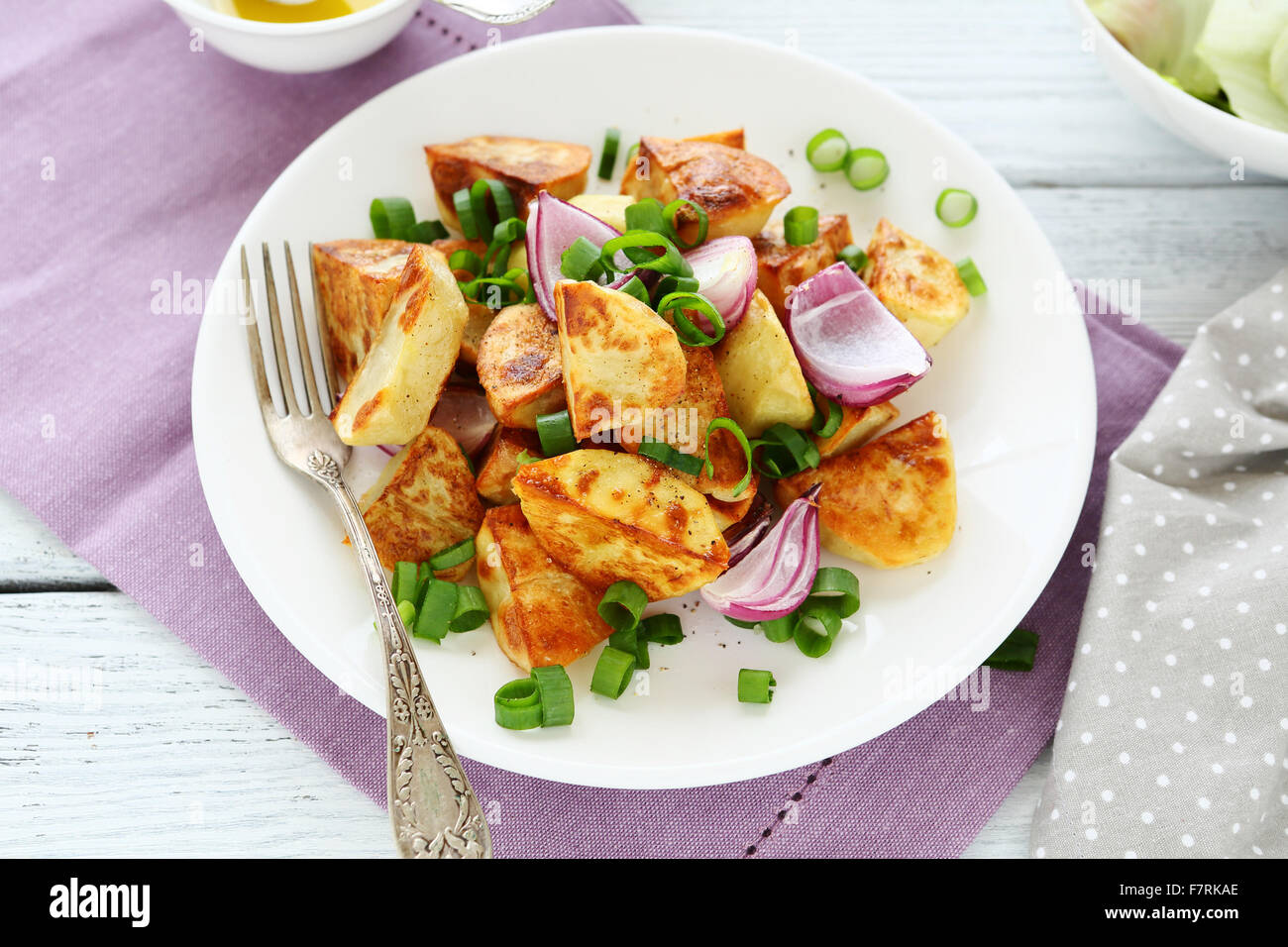 roasted potato wedges on plate, food close-up Stock Photo