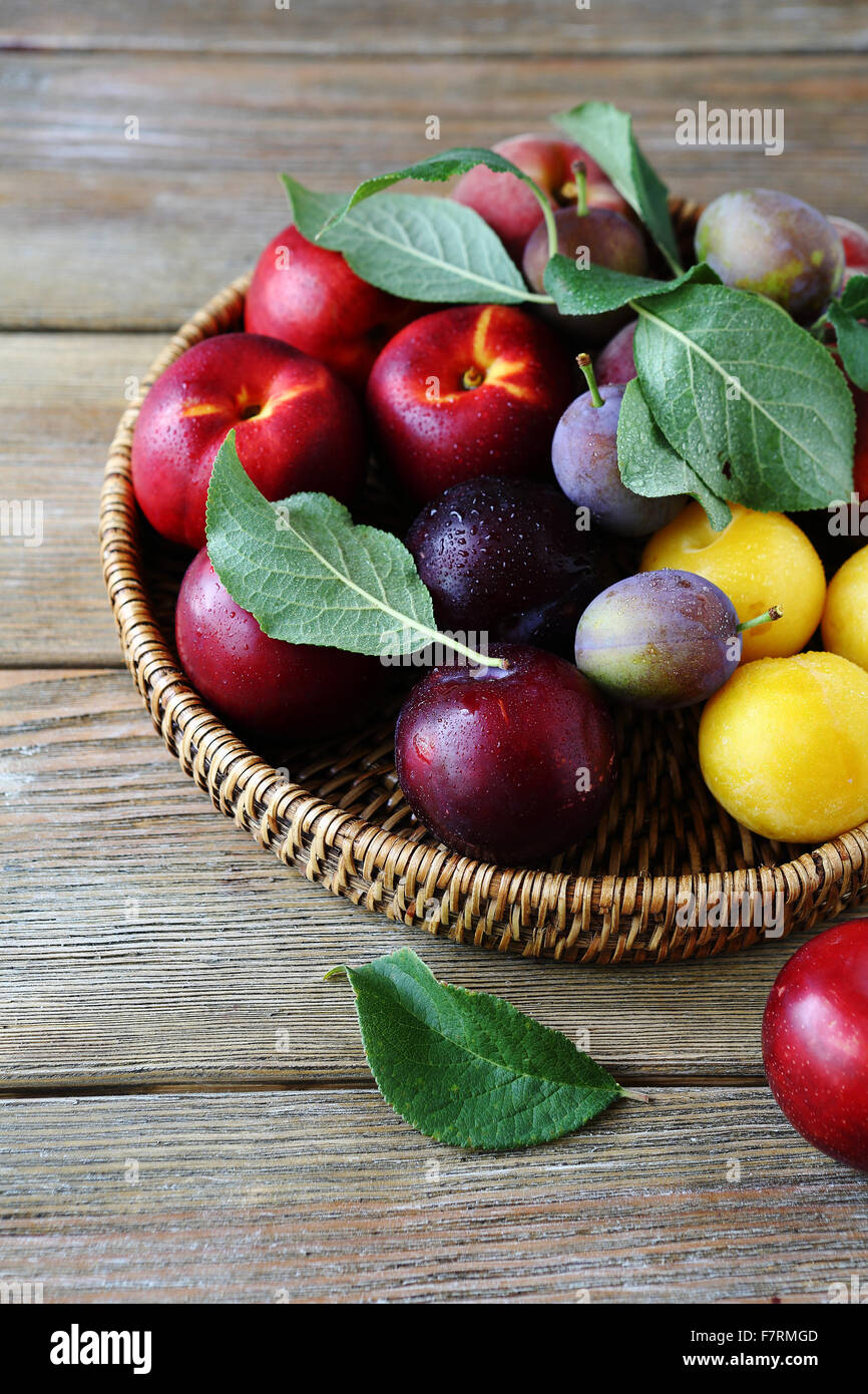 fresh and ripe plums on plate, fruits closeup Stock Photo