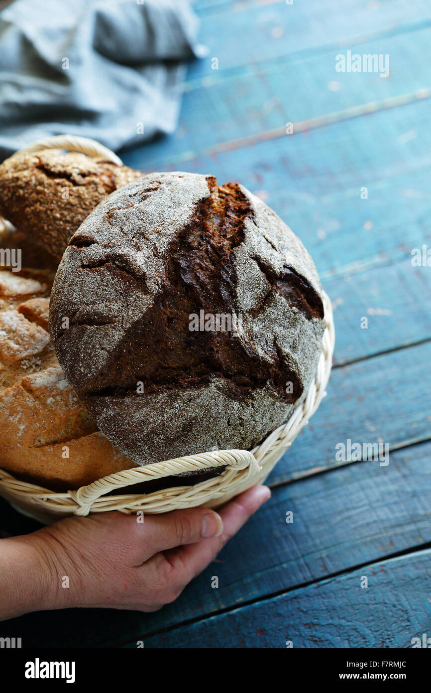 hand with basket full of breads, baking Stock Photo Alamy