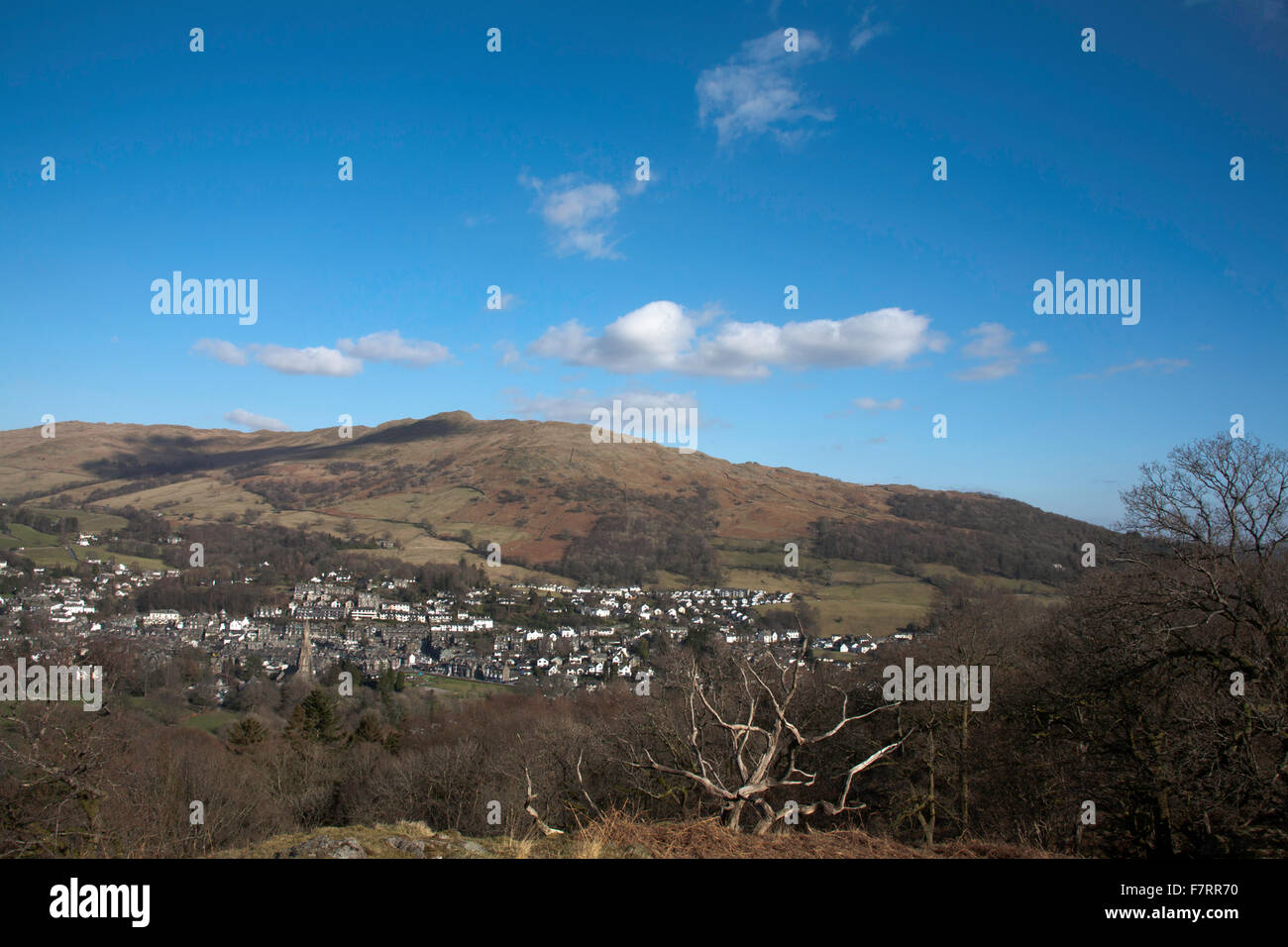 The village of Ambleside lying beneath Wansfell and Wansfell Pike  from Loughrigg Fell Lake District Cumbria England Stock Photo