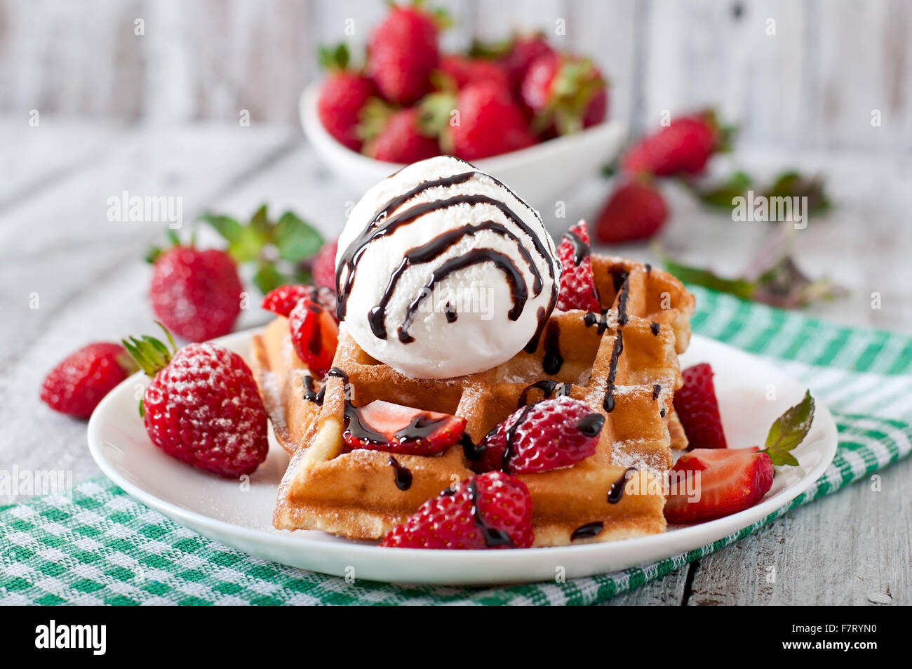 Belgium waffles with strawberries and ice cream on white plate Stock